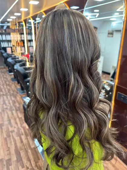The salon view of this ash blonde balayage shows the beautiful dimension and texture created by the color and style.