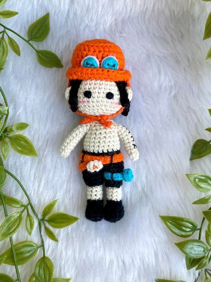 Ace from One Piece! I love creating anime characters because they are so unique and let me be creative. This doll features his signature hat, tattoos, and accessories.