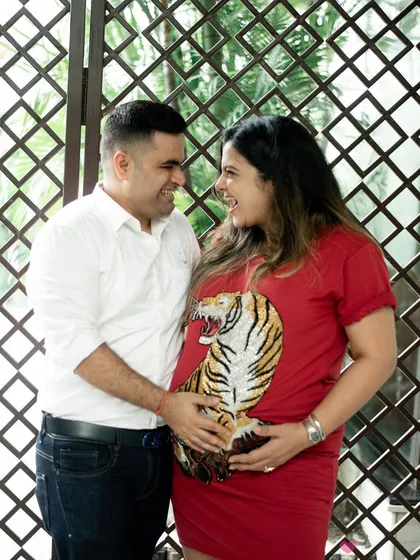 A fun, themed outfit can add so much personality to a maternity shoot. This couple shared a laugh while showing off the tiger graphic on the mom-to-be's shirt, a playful nod to their "little cub" on the way.