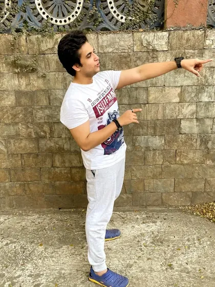 A real candid moment captured during a shoot. The pose is dynamic and full of energy, reflecting my "lessgoo" attitude.