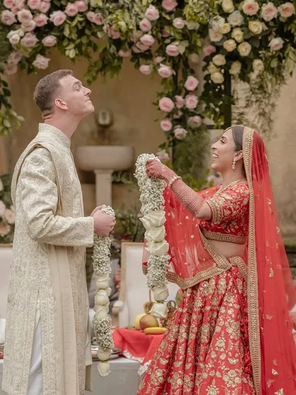 Kingsley instinctively makes it hard for Sheline during the varmala, a playful tradition in Indian weddings. His spontaneous fun and her joyful reaction make for a perfect, unscripted moment.