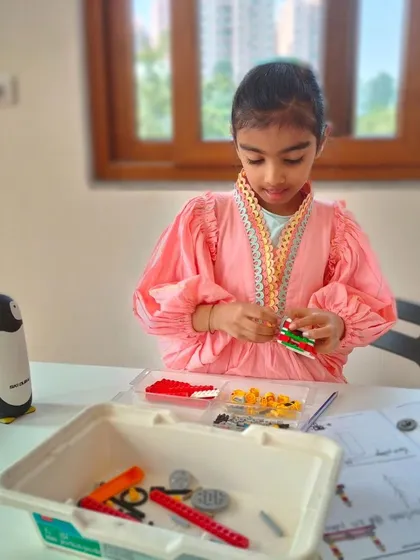 Every piece has a purpose. This student is carefully selecting components for her project, learning about design and function in our engaging summer camp at the Whitefield branch.