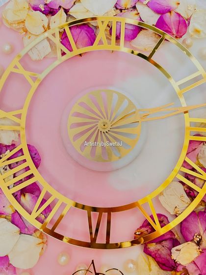 A top-down view of the floral clock, showing the beautiful arrangement of petals around the elegant golden clock face.