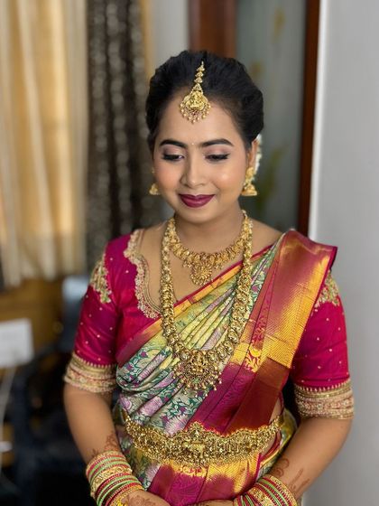 Komal looking down, showing the soft blend of her eyeshadow. The look is elegant and perfect for the occasion.