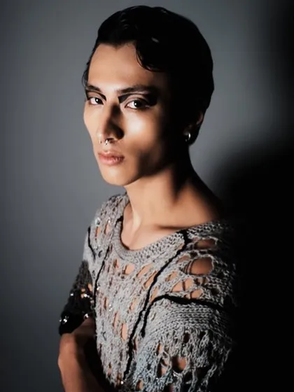 A powerful portrait from a men's fashion editorial. I used a graphic, smudged eyeliner and a sleek, side-parted hairstyle to create a modern and androgynous look.