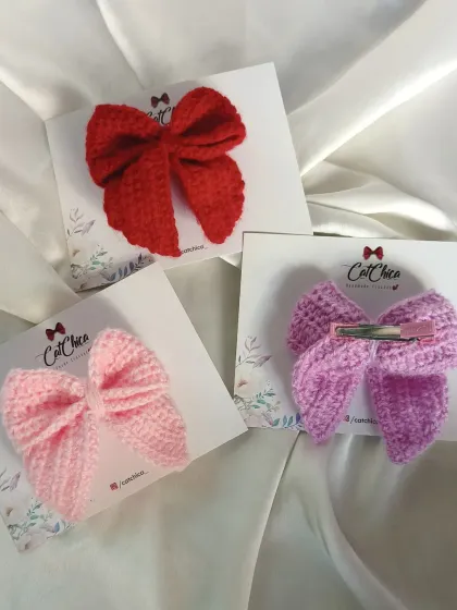 This image shows the front and back of our Sailor Bows. You can see the neat crochet work and the secure alligator clip we use on the back.