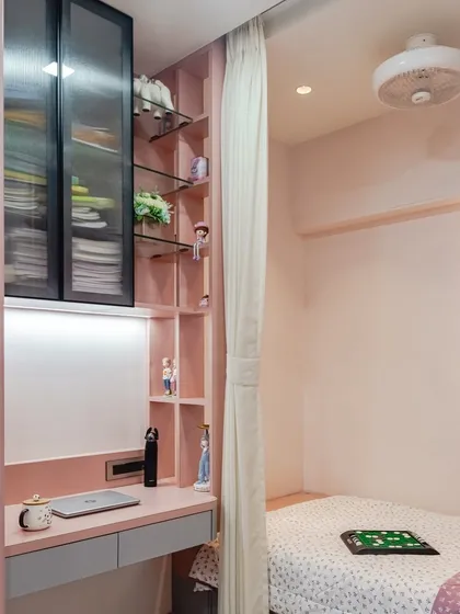 For this room, I designed a compact and stylish study nook that flows seamlessly into the bedroom's storage. The soft pink tones, combined with glass-front upper cabinets and open shelving, create a space that is perfect for both focused schoolwork and displaying personal treasures.