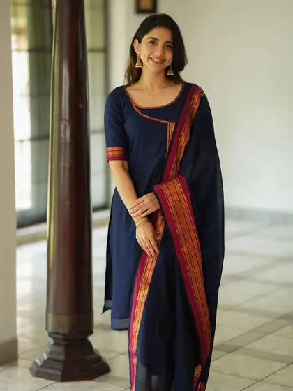 A simple and elegant navy blue kurta set with a traditional woven border on the dupatta. This classic design is a versatile staple for any ethnic wardrobe.