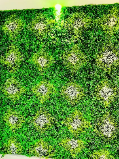 This custom panel features a diamond pattern created by using different shades and textures of green moss. It's a subtle yet sophisticated design that adds visual interest to a standard green wall.