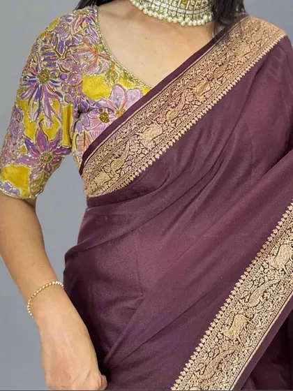 A detailed shot of the border on our dark brown Banarasi saree. The intricate weaving features traditional motifs, showcasing the fine craftsmanship that goes into each piece.
