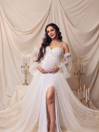 A confident and radiant portrait, with the mom-to-be looking directly at the camera, glowing with happiness.