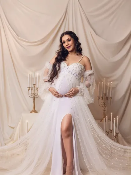 A confident and radiant portrait, with the mom-to-be looking directly at the camera, glowing with happiness.