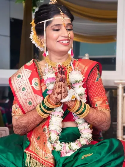 A candid moment of prayer during the wedding rituals. The makeup is designed to be long-lasting and picture-perfect from every angle, even during the most emotional parts of the day.