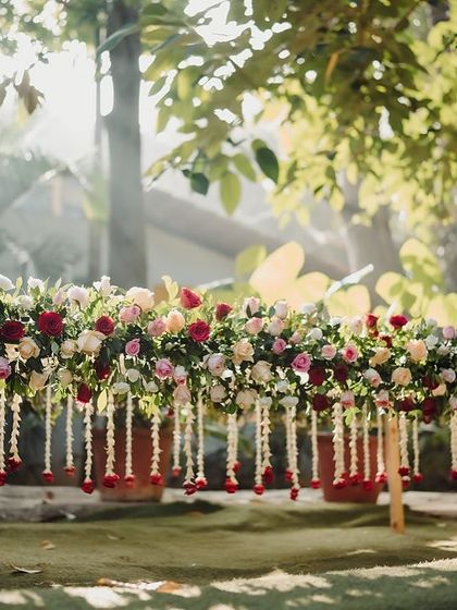A beautiful floral arrangement on a welcome table, with hanging jasmine strings adding a touch of traditional South Indian charm.