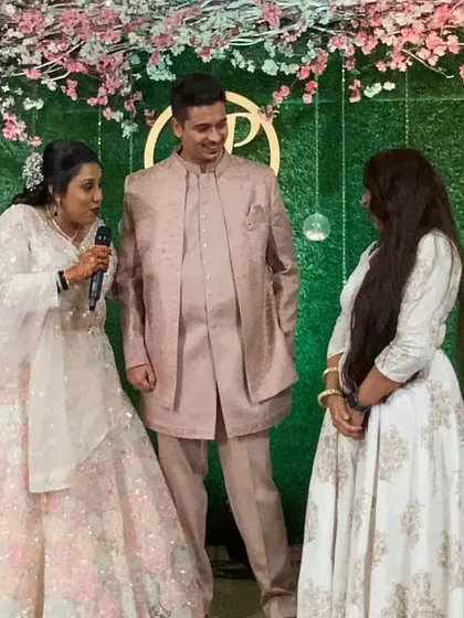 On stage with the couple, sharing a moment after their performance. My job is to make sure everything runs smoothly.