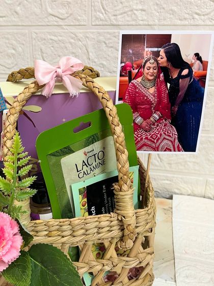 A close-up of the sister's Rakhi hamper, showing the Lacto Calamine face mask and other self-care goodies.