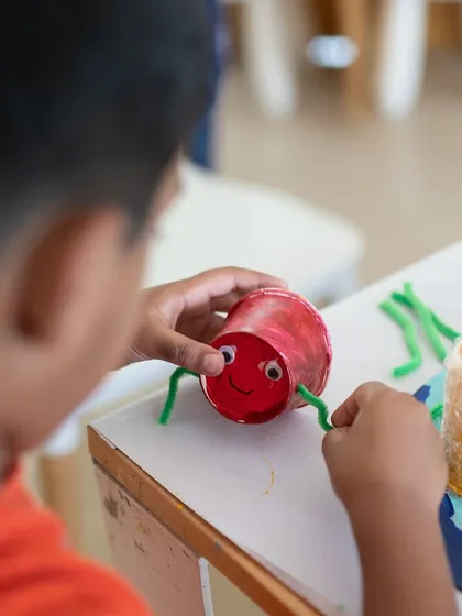 It's amazing what you can create with a paper cup and some pipe cleaners! This student is making a cute crab as part of a mixed-media sculpture project. I encourage using everyday items to spark imagination.