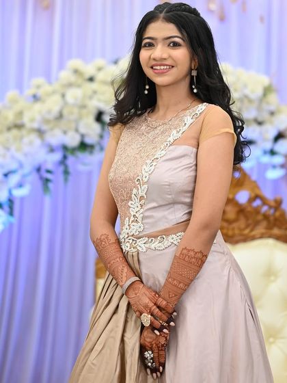 A bright smile and beautiful henna make for the perfect party look.