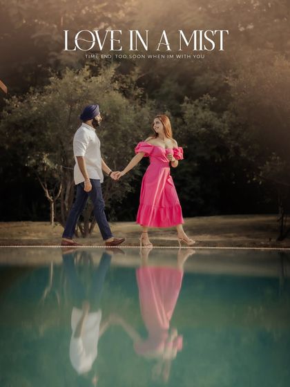 "Love in a Mist." A stunning reflection shot of the couple walking by a pool. The misty, romantic atmosphere and their reflection in the water create a truly magical image.