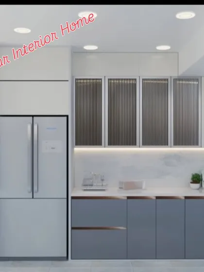 A sophisticated modular kitchen with grey and white cabinets. The upper cabinets feature fluted glass, adding a touch of elegance and texture.
