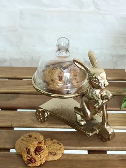 The whimsical golden rabbit on a scooter stand, serving cookies under a delicate glass cloche. This piece is crafted to add a playful yet elegant touch to your tea-time rituals.