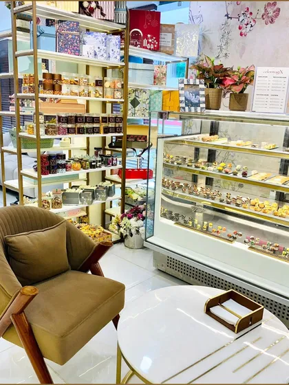 A cozy corner of our showroom featuring a comfortable chair and a display of our gourmet treats and smaller gift items. This highlights the retail experience we offer to our walk-in customers.