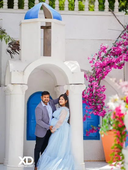 A beautiful couple's portrait at a Santorini-inspired set, complete with blooming bougainvillea.
