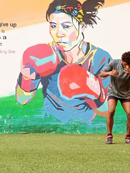 A student practices his shadowboxing form in front of our Mary Kom mural. We draw inspiration from legends to fuel our own journey.