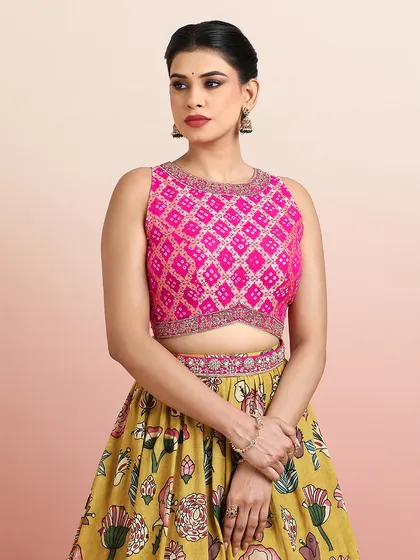 A close-up of the pink embroidered blouse, featuring a geometric Bandhani-style pattern that contrasts beautifully with the floral skirt.