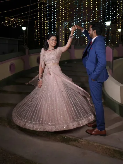 A romantic dance between the couple at their reception. The bride's lehenga flows beautifully, and her makeup stays perfect.
