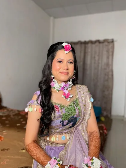 The complete Haldi look, with a focus on a radiant complexion and a simple, elegant hairstyle.