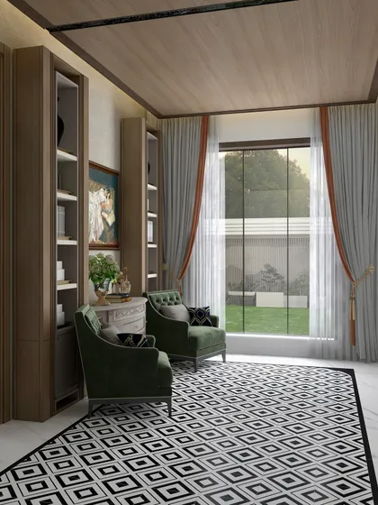 This view shows how the large window floods the room with natural light, enhancing the rich textures of the wood, the geometric floor, and the velvet armchairs.
