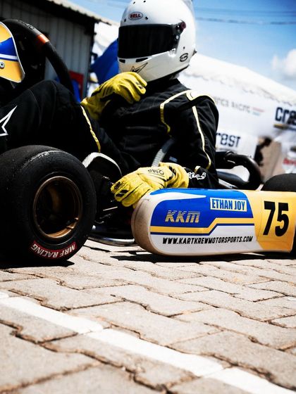 A low-angle shot of our driver's kart, showing the KKM branding.