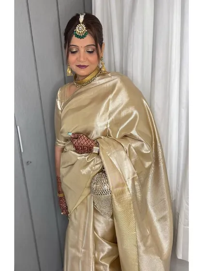It's an honor to get the mother of the bride ready. For her, I created a timeless and elegant look with a classic hair bun and makeup that enhanced her natural grace, perfectly complementing her beautiful golden saree.