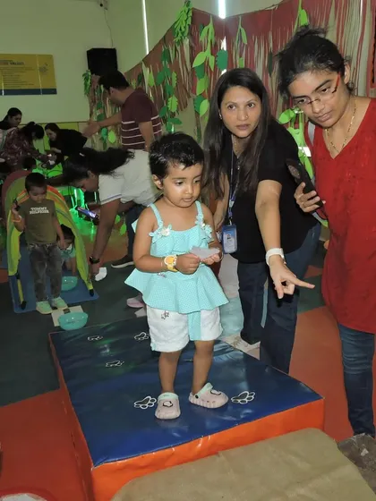 A mother and teacher point out details in the jungle-themed decor to a curious child. Our events are a great opportunity for parents and teachers to interact in a relaxed, informal setting.