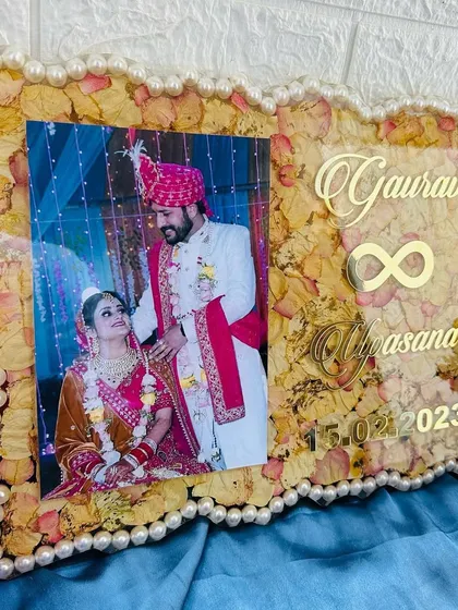 A clear, frontal view of the frame, showing the elegant arrangement of the photo and text over the floral background.