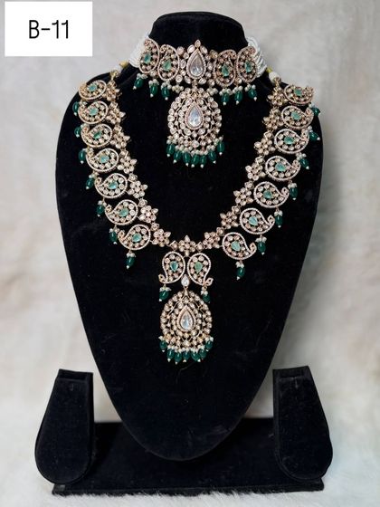 For a unique touch, my rental set B-11 features a beautiful paisley motif design in both the choker and the long necklace, accented with green stones.