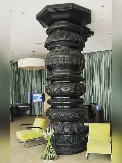 Another view of the magnificent Hoysala pillar in our lobby, contrasting with modern lime green chairs. This fusion of heritage and contemporary design is at the core of our aesthetic.