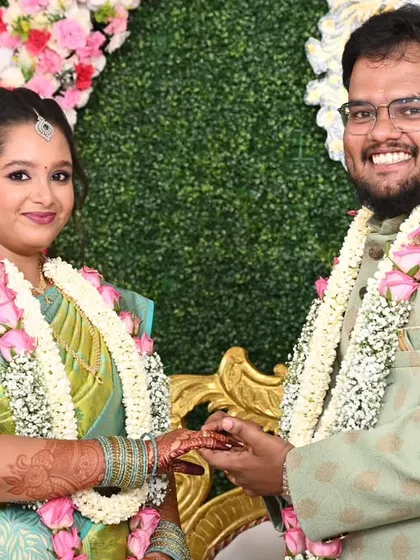A happy couple during their engagement ceremony. The bride's makeup is fresh and radiant, matching the joyous occasion.