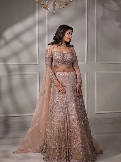 A beautiful shot of the engagement bride, with soft light creating a dreamy effect. Her pastel lehenga and soft makeup are the epitome of modern elegance.