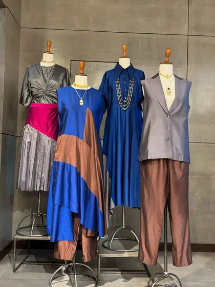 A wider view of the modern collection, including a stylish grey vest and pant set, perfect for a contemporary, androgynous look.