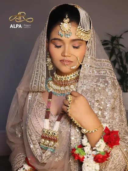 A serene portrait where the focus is on the bride's flawless skin and the elegant way her dupatta frames her face.
