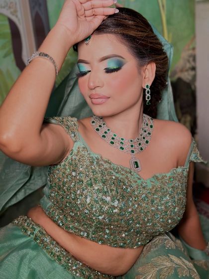 A close-up of the mint green eye makeup. The colors are blended seamlessly for a professional finish.