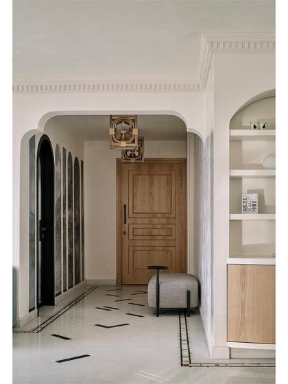 The entry foyer of Eden House, where unique marble flooring with green inlay resembles a carpet, immediately setting a tone of unconventional, nature-inspired design.