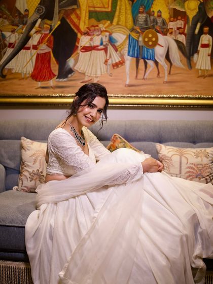 A relaxed and happy pose in the white lehenga. It's important to be comfortable while looking your best.