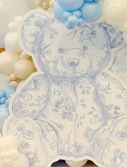 A detailed shot of the custom-printed teddy bear, featuring the intricate blue floral toile pattern that defines this elegant Dior-themed baby welcome decor.