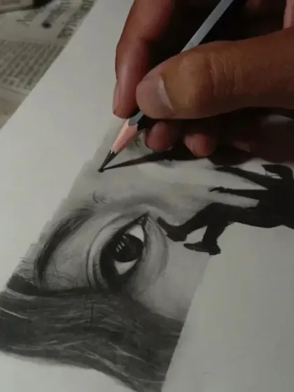 Here you can see me adding the final details to the conceptual eye sketch. The use of a dark pencil for the silhouette creates a stark contrast against the softly shaded eyes.