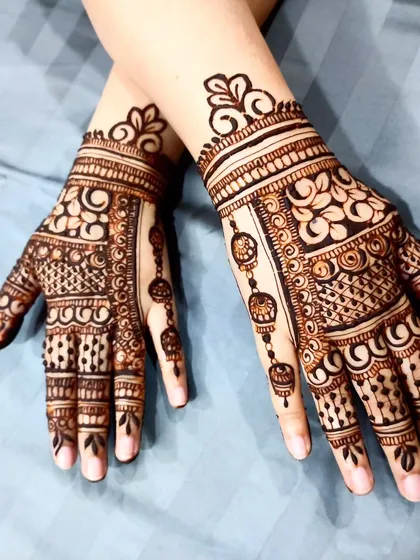 A beautiful design with hanging jhumka elements, showing how to create delicate, jewelry-like details.