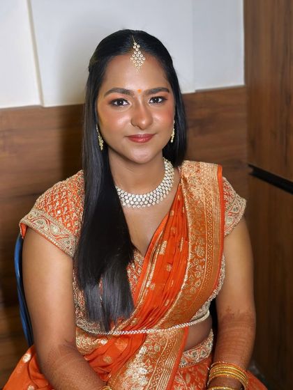 A smiling portrait, her makeup looking fresh and radiant.