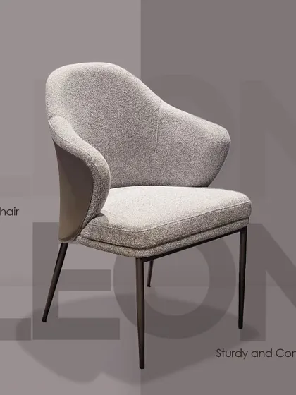 The 'LEON' dining chair is designed for both sturdiness and comfort. It features a unique dual-material backrest and a gently curved seat on slim metal legs.